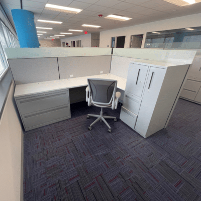 Allsteel Terrace Cubicle Workstation in 6' x 8' size with grey tone fabric, white L-Shape worksurfaces, and silver paint tone metal storage